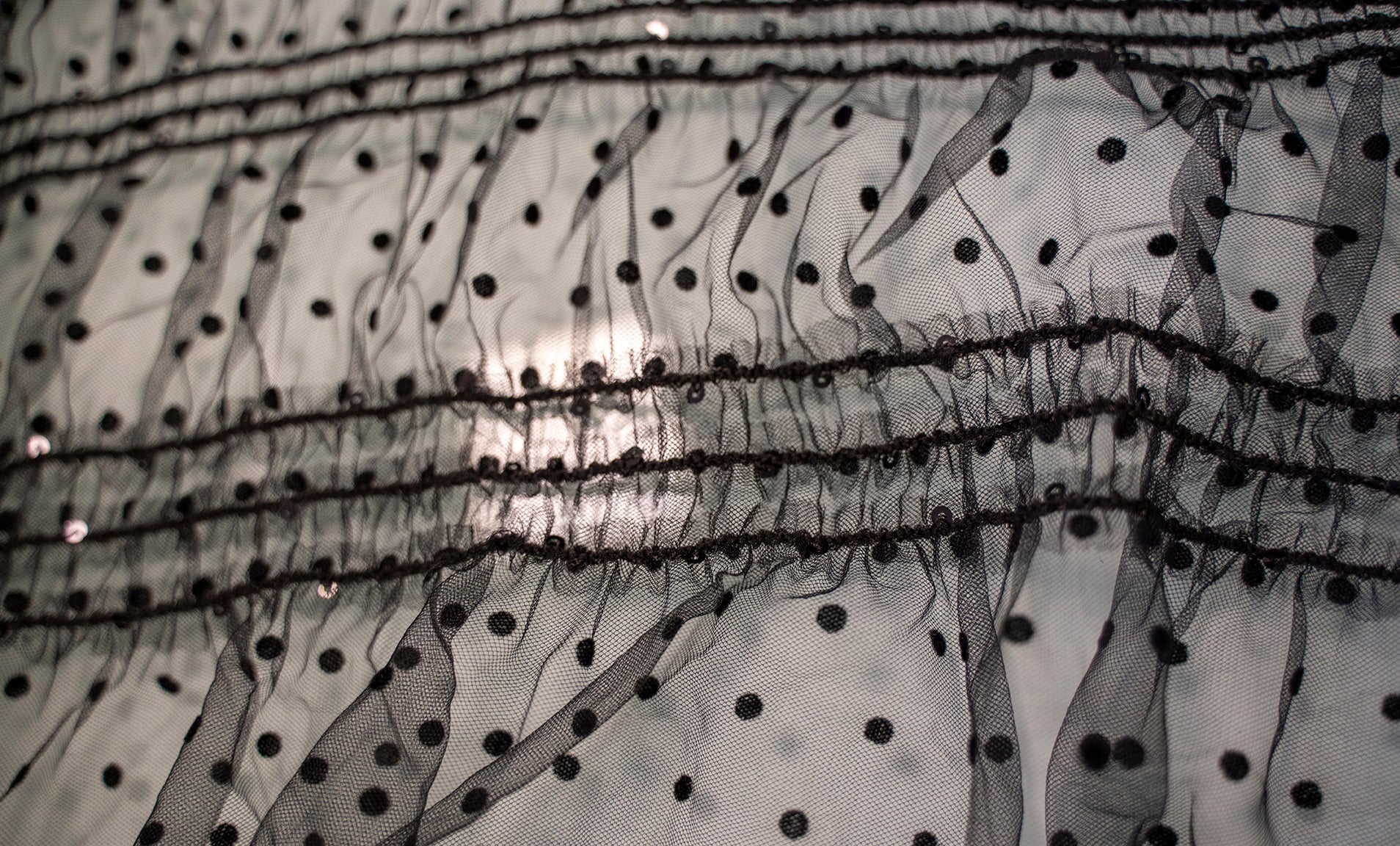 PLEATED SEQUINED FABRIC ON BLACK POOL TULLE